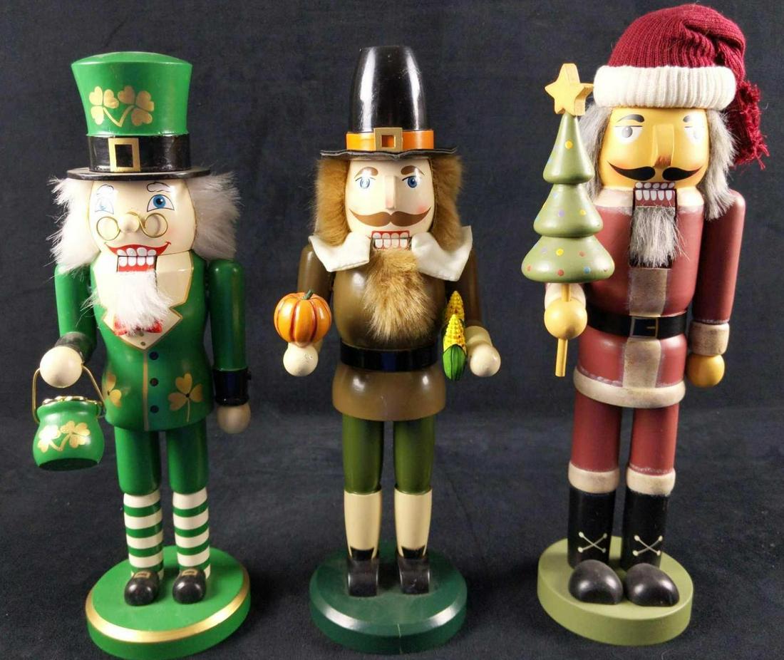 Christmas Thanksgiving St Patricks Day Nutcrackers: This lot includes: (1) Wooden St Patrick's Day Nutcracker by Taizhou Rival Arts Co. Is approx 4" x 4" x 14". (1) Wooden Thanksgiving Pilgrim Nutcracker by (Unknown company). Is approx 4" x 4" x 14". (