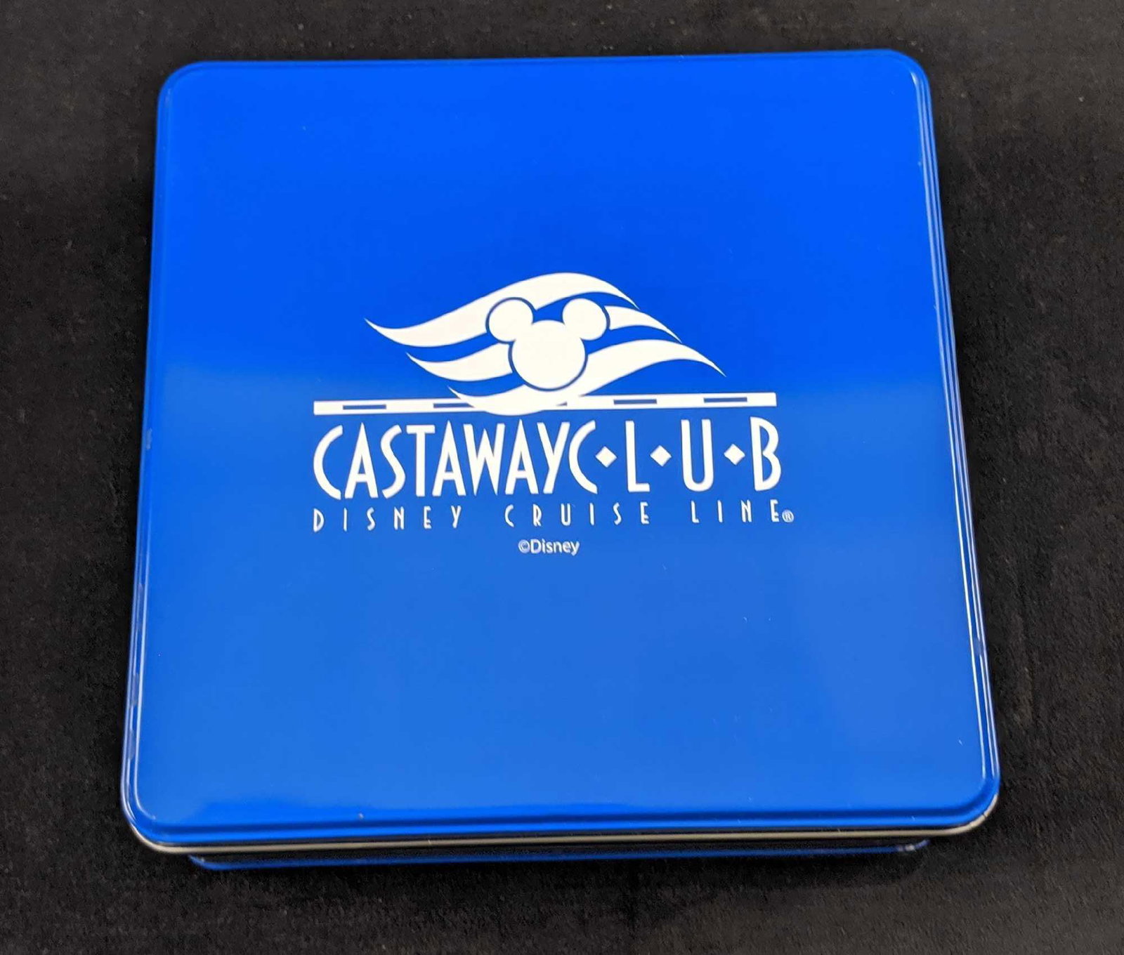 Disney Cruise Line Castaway Club Cruise O Grams Game: Includes: Disney Cruise Line black ink pen (works!) Hinged Tin Box (White Sleeve Cover) Cruise O Grams Game Tiles in Zippered Pouch Deck of Cards (unopened) Castaway Notepad (still in original plastic