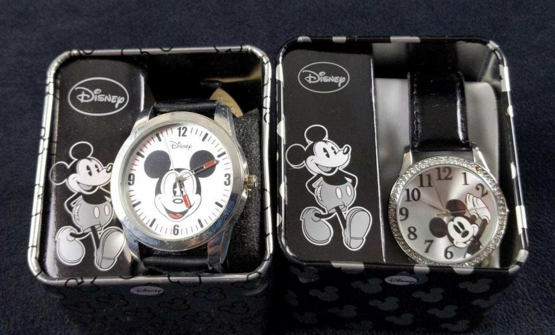 Two Disney Mickey Mouse Accutime Adults Watch: This lot includes two stainless steel Mickey Mouse watches. Both will need new batteries as they have been sitting in storage for a few years. Watches are unused and are still firmly attached to their