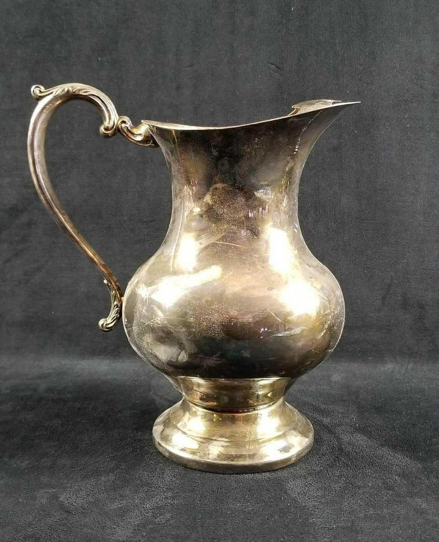 Vintage Taunton Silver Plated Lenox Water Pitcher: Vintage Taunton Silver Plated Lenox Water Pitcher is in good condition with some tarnishing and minor corrosion on the interior. There is a nickel-size dent on the belly of the pitcher. The handle has