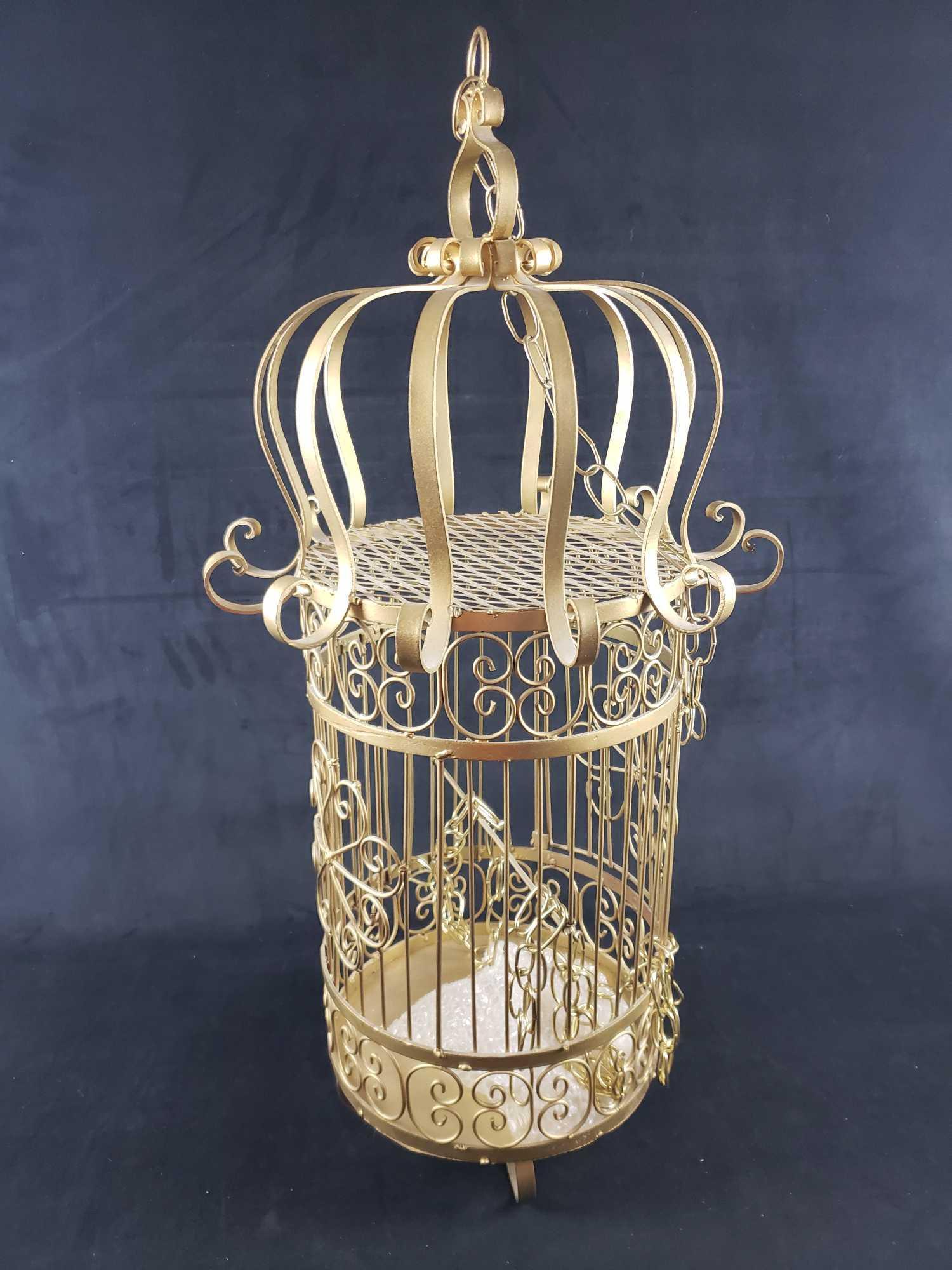 Mid Century Mexican Bird Cage: Mid Century Mexican Bird Cage. This bird cage is in great used condition. The top ring has some signs of rust, but otherwise there are no known signs of damage. The bird cage is gold painted steel. It