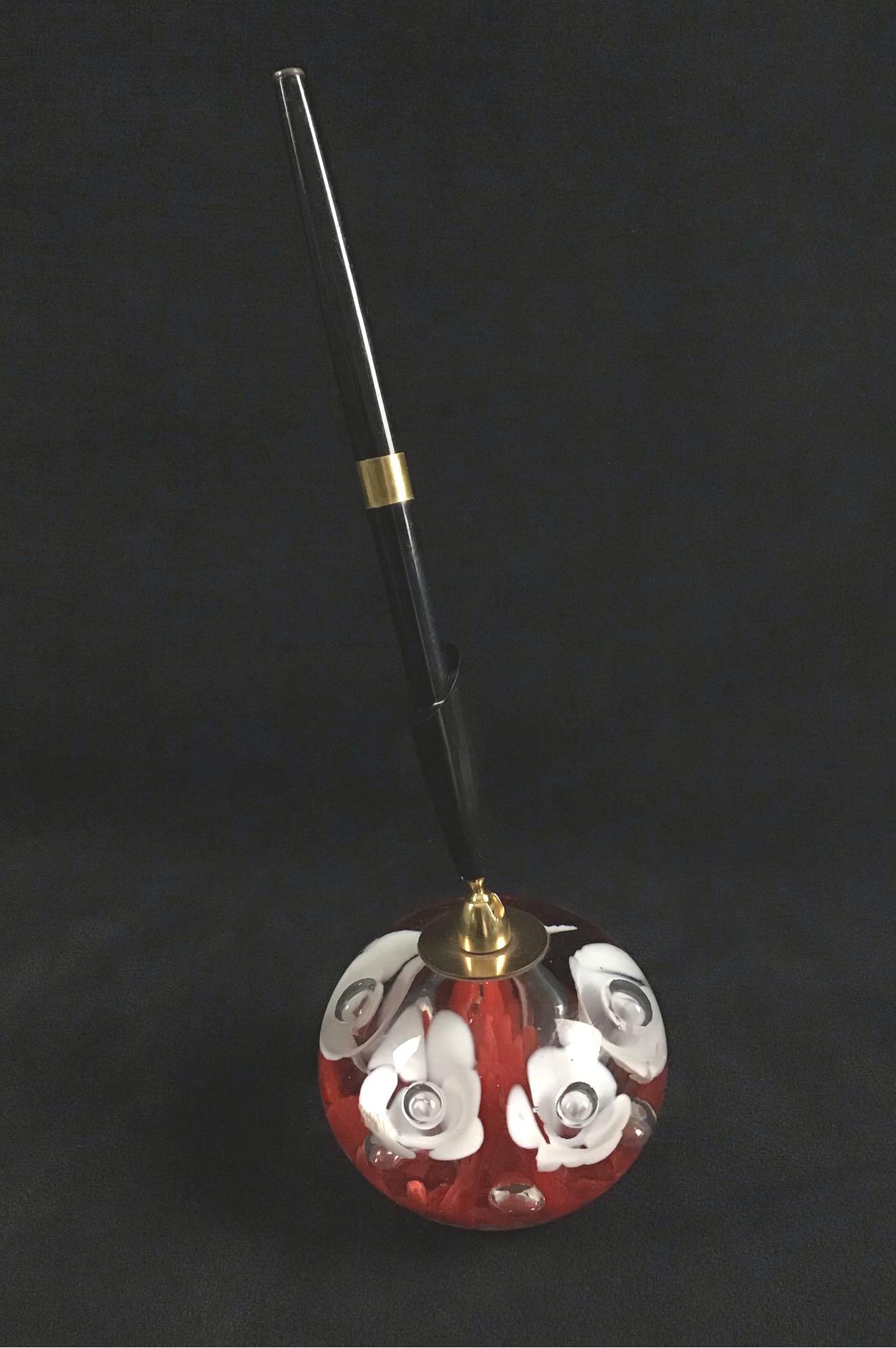 Glass Art Paperweight Pen Holder St Clair: Glass Art Paperweight Pen Holder St Clair. This is a glass art paperweight pen holder. Inside the glass you can see white trumpet flower designs and controlled bubbles. Around the trumpet flowers you 