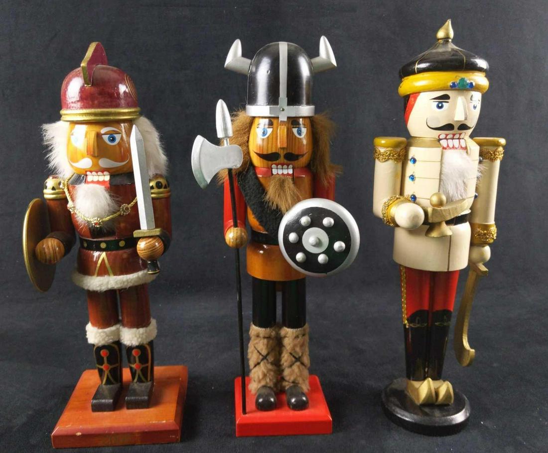 Warriors Three Wooden Nutcrackers Aladdin Christmas: This lot includes: (1) Wooden Viking With Polearm and Shield Nutcracker. Maker is unknown. Base is marked on the bottom with a 2010. Is approx 3 1/2" x 3" x 14". Helm should be on nose, but is loose.