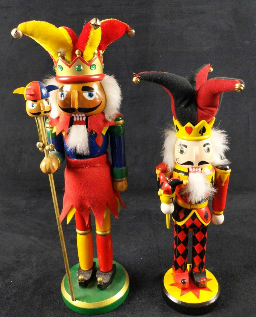 Two Wooden Jester Harlequin Nutcrackers: This lot of Jester Nutcrackers consists of: (1) Classic Style Jester With Plush Hat Wooden Nutcracker. Colorful Jester holds a marotte in his right hand. Is approx 4" x 4" x 15 1/2". Maker is unknown.