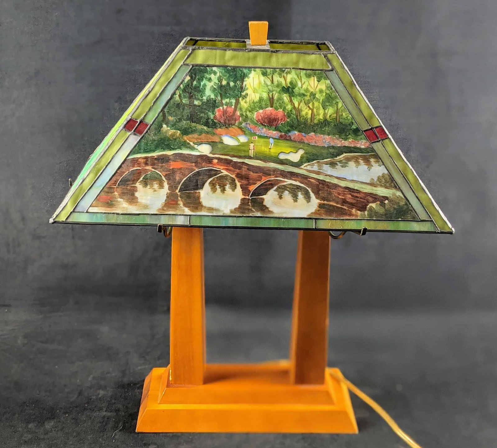 Augusta National Golf 12th Hole Stained Glass Lamp: Augusta National/Masters Golf 12th Hole Slag/Stained Glass Desk Lamp. Rare and unusual golf lamp with hand-painted detail of the 12th hole at Augusta National Golf Club. Hogan Bridgeâ€™ is on two