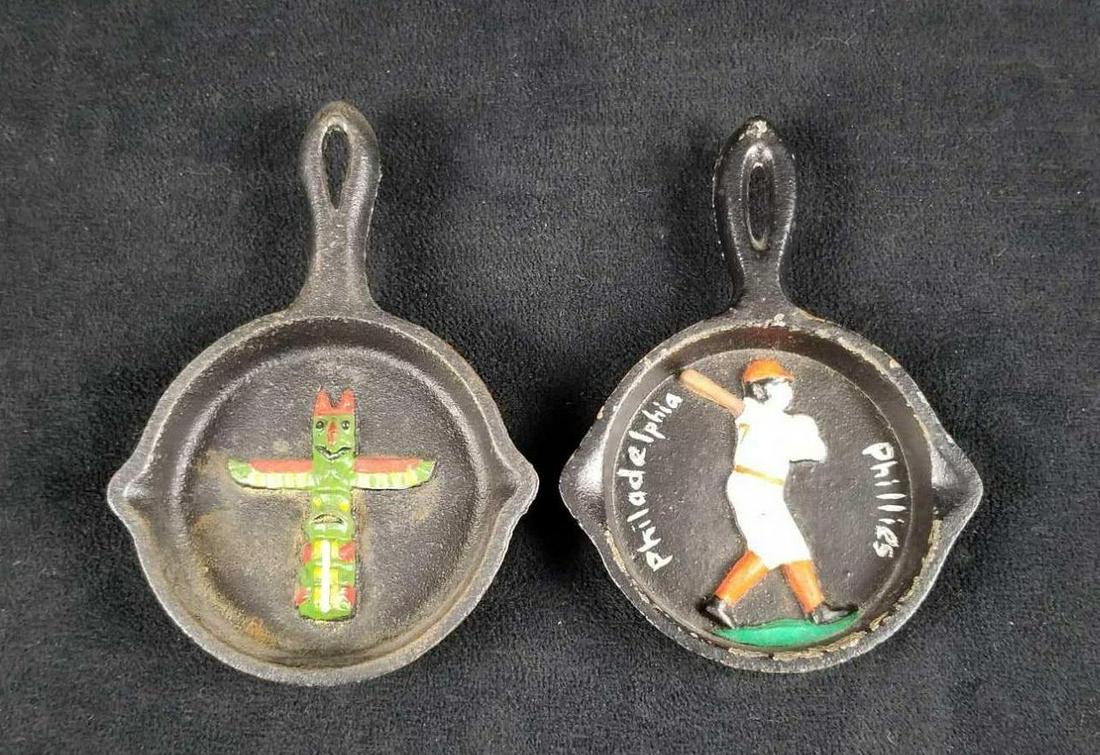Vintage Mini Cast Iron Skillet Hand Painted Totem PA: This lot contains 2 vintage 3"x5" mini cast iron skillets. Used as wall hanging or ashtrays. One has a totem pole and the other has a "Philadelphia Phillies" baseball player on it. Maker is unknown an