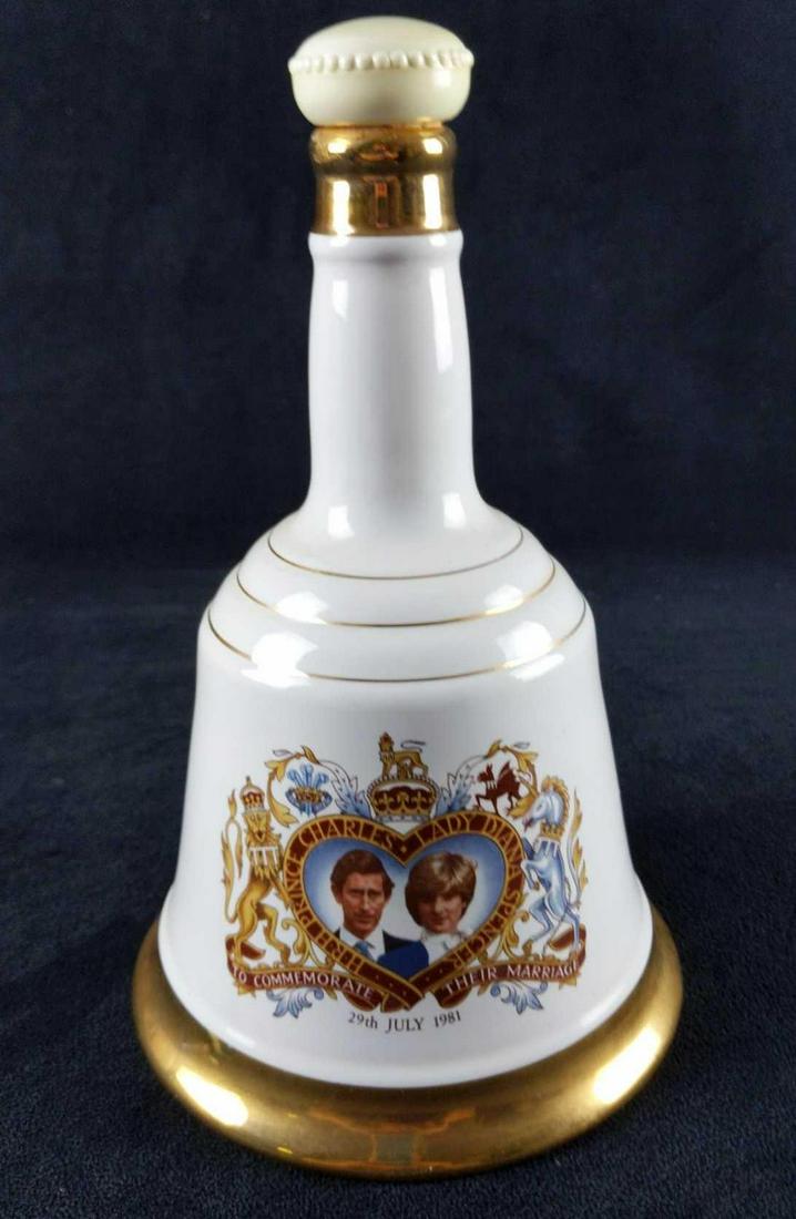 Bells Prince Of Wales Lady Diana Spencer Decanter: A 75 cl ceramic decanter of Bell's Scotch Whisky, produced in celebration of the wedding of Prince Charles and Lady Diana Spencer in 1981. Bell-shaped bottle is approx 6" x 6" x 9 1/2". Please note th