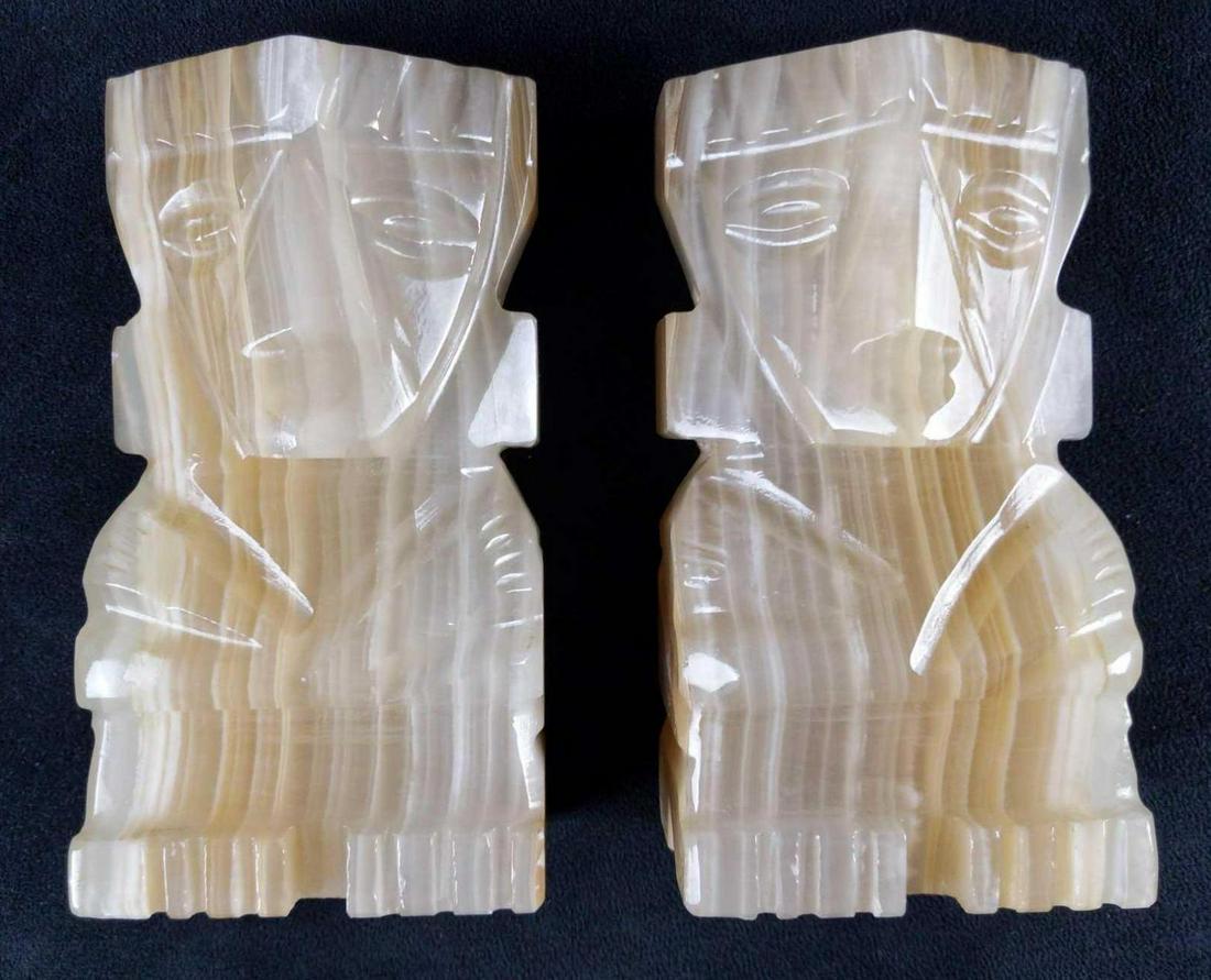 Hand Carved Alabaster Hawaiian Style Tiki Bookends: Hand Carved Alabaster Hawaiian Style Tiki Bookends. Creator and date of creation is unknown. Tiki Bookends are approx 4" x 2 1/2" x 7". Both are in good, used condition with no known damage.