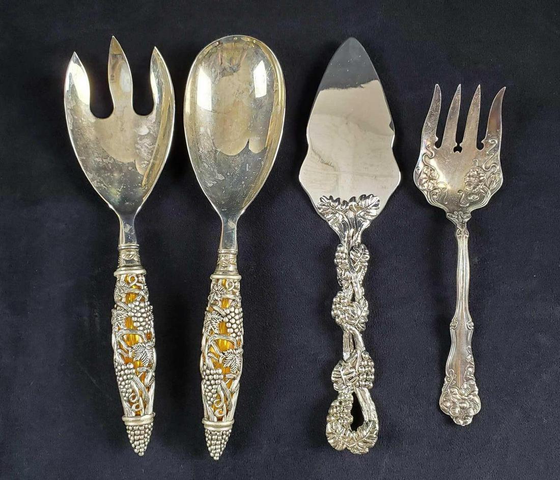 Vintage Silver Plated Serving Utensils Lot Of Four: This lot includes silver-plated serving utensils: (1) Solid Pie Server With Grape Pattern by Godinger. Is approx 11" across. Server is in good, used condition with light wearing. (1) VM Serving Fork W