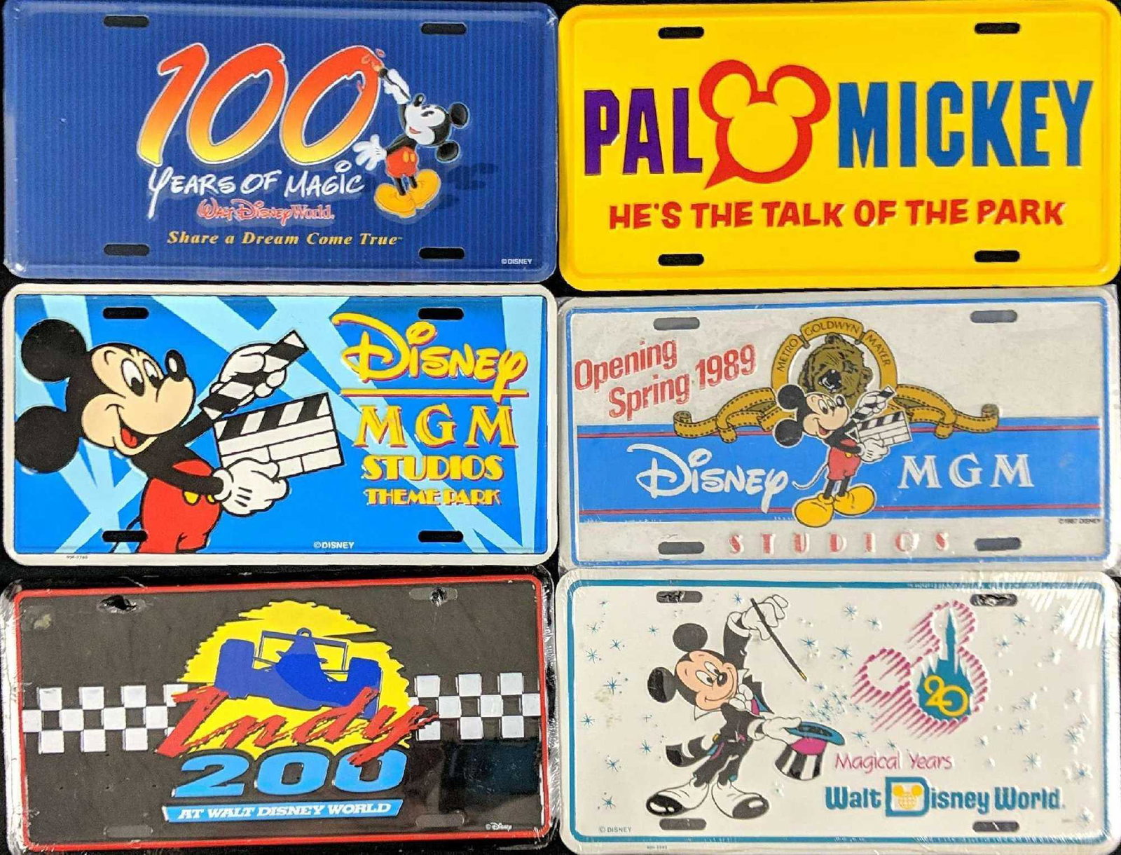 Six Vintage Disney World Front License Plates: This lot consists of: (1) Pal Mickey: He's The Talk Of The Park. Was used to promote Pal Mickey Talking Plush Doll. (1) Disney MGM Studios Theme Park. (Now Disney's Hollywood Studios. (1) Opening Spri