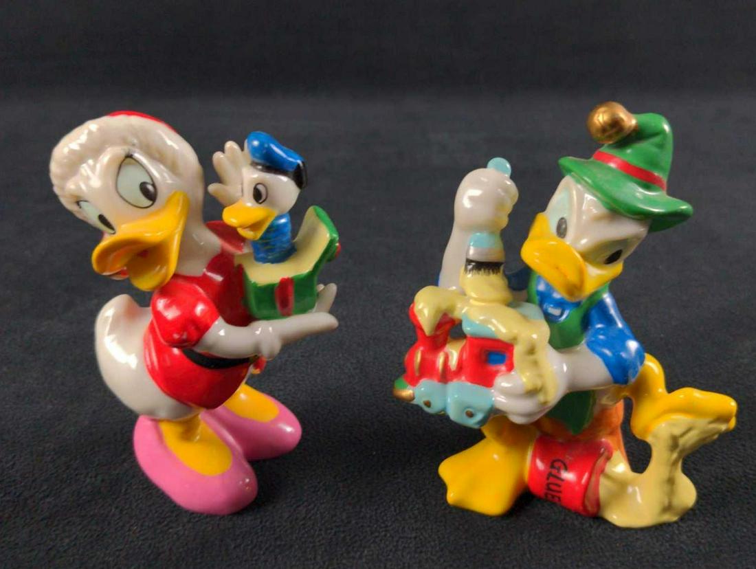 Disney Donald Daisy Duck Ceramic Christmas Figurines: This lot consists of: (1) Enesco Ceramic Hand-Painted Donald Duck. The "Duck With Only Bad Luck" finds himself with a flipper full of glue as he tried his best to paint a toy train. "Oh, Phooey!". Is 