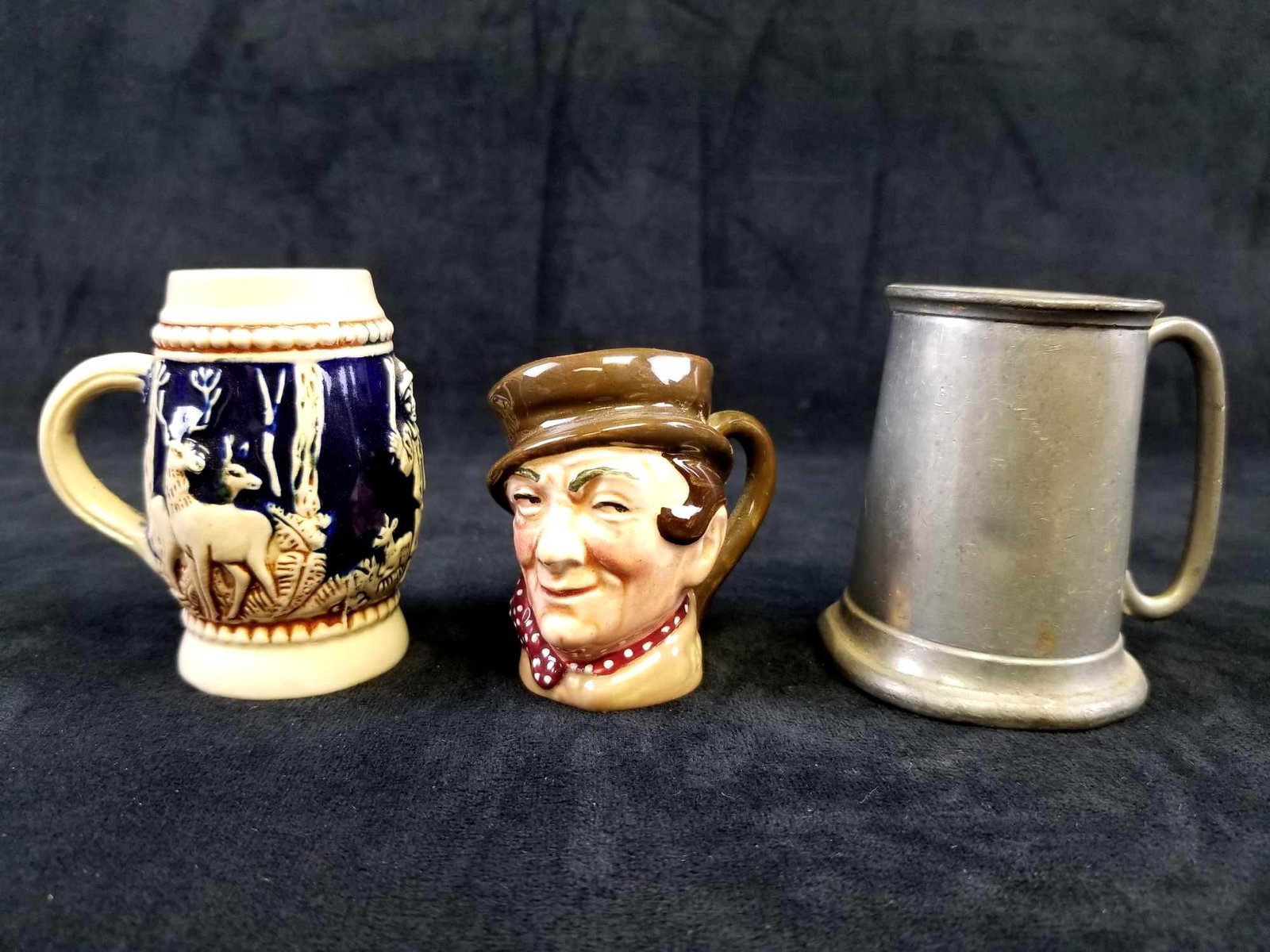 Lot of 3 Miniature Beer Steins: From Left to Right: Vintage Mini German Beer Stein Vintage Mini Royal Doulton Sam Weller Toby Mug Jug Mini Sheffeild Pewter Stein from England.