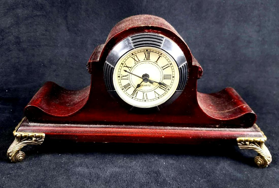 Quartz Mantle Clock: Quartz Footed Mantle Clock. This mantle clock is in good used condition. The clock has minor signs of wear and is untested. Light patina on surface. Clock is made of cherry wood. Measures 11" L x 4" W