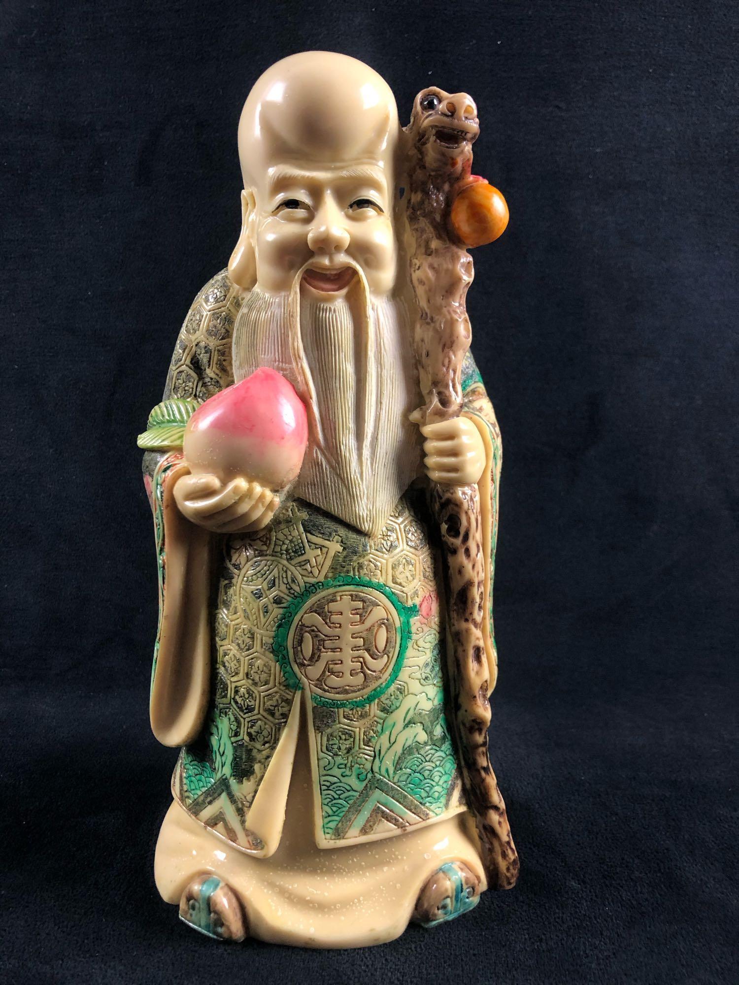 Chinese Art Wise Man Sculpture Large Faux Ivory: Chinese longevity Wiseman god with lucky peach. This is a Chinese Wiseman made of resin. His very large forehead signifies wisdom and his long beard, long life. He is always seen carrying a long staff