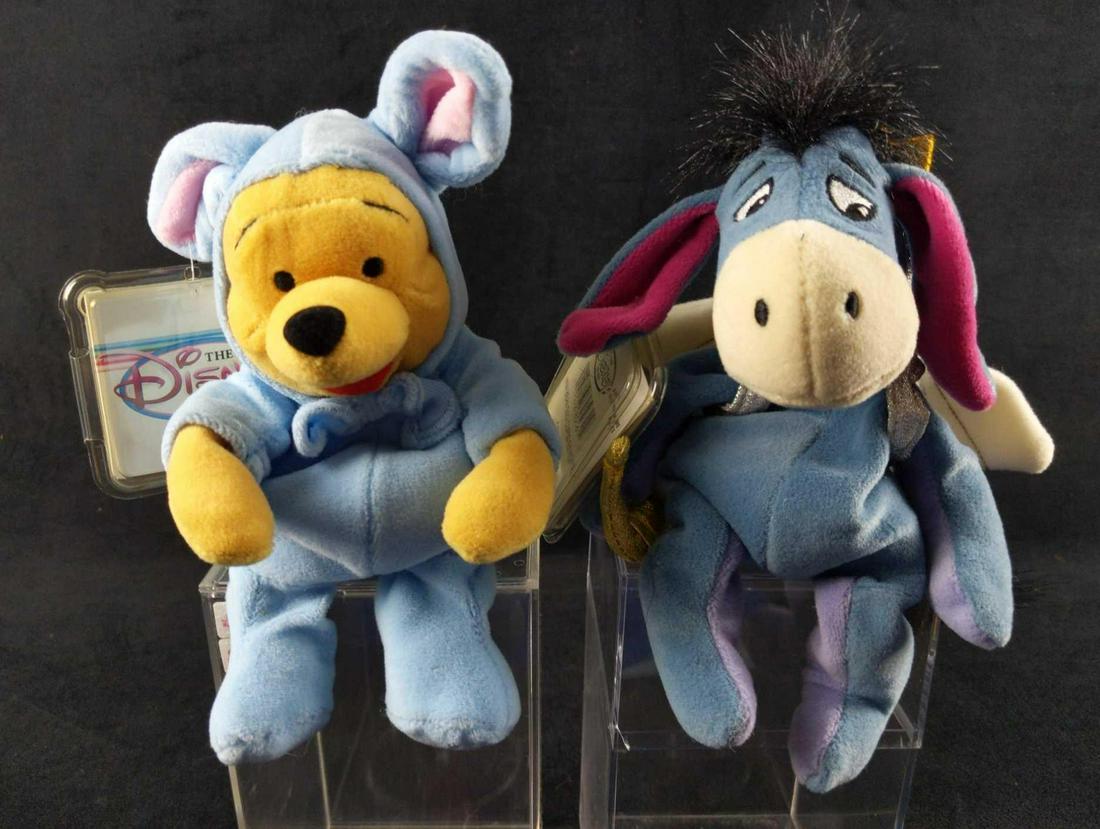 Two Disney Bean Bag Plush Cupid Eeyore Sleepy Pooh: This lot includes: (1) Cupid Eeyore. Doll is approx 6" x 4 1/2" x 9". (1) Winnie The Pooh In Bunny Pajamas. Doll is approx 5" x 3 1/2" x 9". Both come with protective acyclic cases that are approx 4" 