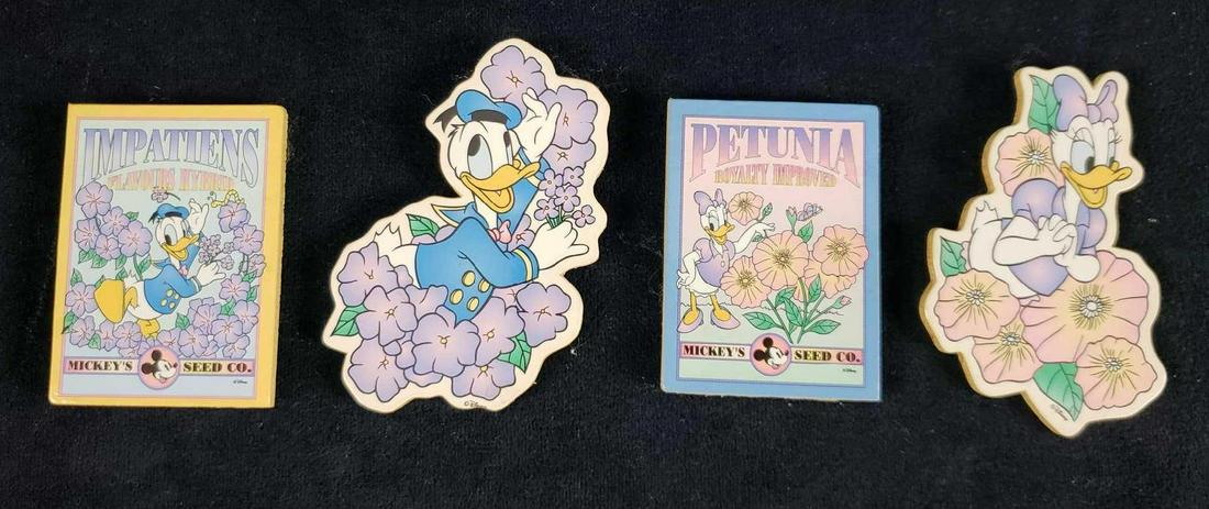 Lot of 4 Donald and Daisy Duck Floral Magnets: Lot of 4 Donald and Daisy Duck Floral Magnets. This lot of Donald Duck magnets is in overall great used condition. The magnets have a wood base and Donald/Daisy duck decal on the front. Included in th