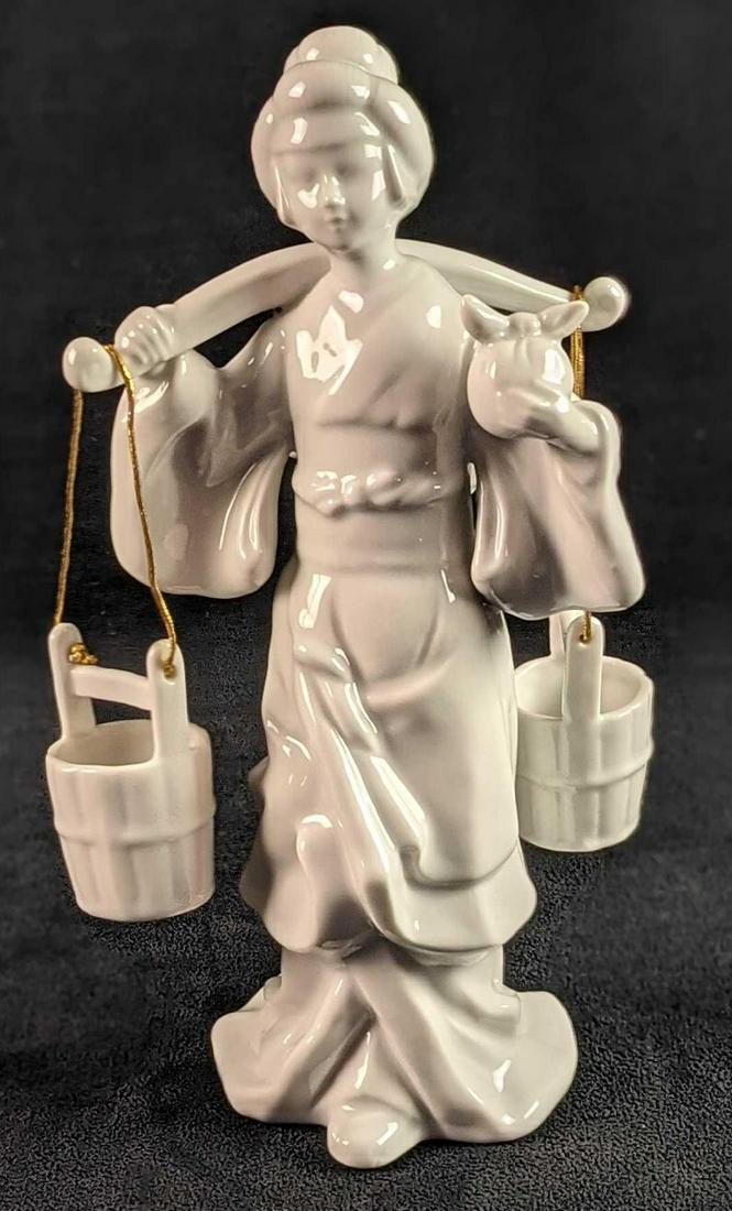 Blanc De Chine White Porcelain Woman Carrying Water: Blanc De Chine White Porcelain Woman Carrying Water. Made in Korea. Is approx 5" x 3" x 9 1/2". Is in a good, vintage conditon with a small scratch on the figurine's right hand. Is marked with a gold 