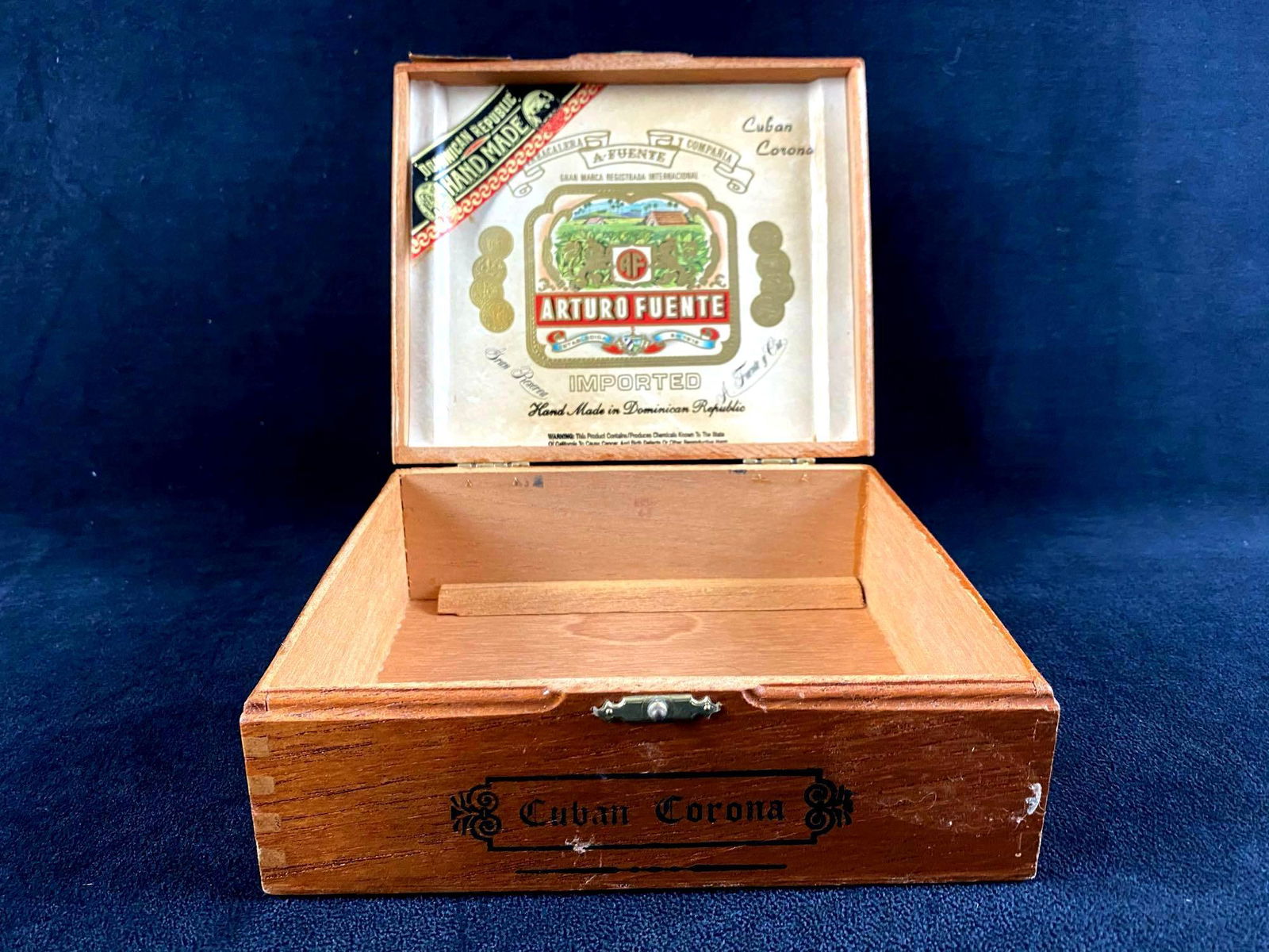 Arturo Fuente Wooden Empty Cigar Box - Cuban Corona: ARTURO FUENTE CUBAN CORONA WOOD CIGAR BOX SINGLE CLASP ON FRONT BOX MEASURES - 7 X 6 7/8 X 2 ¾" H BOX CONTAINS NO CIGARS BOX IS MADE IN DOMINICAN REPUBLIC.