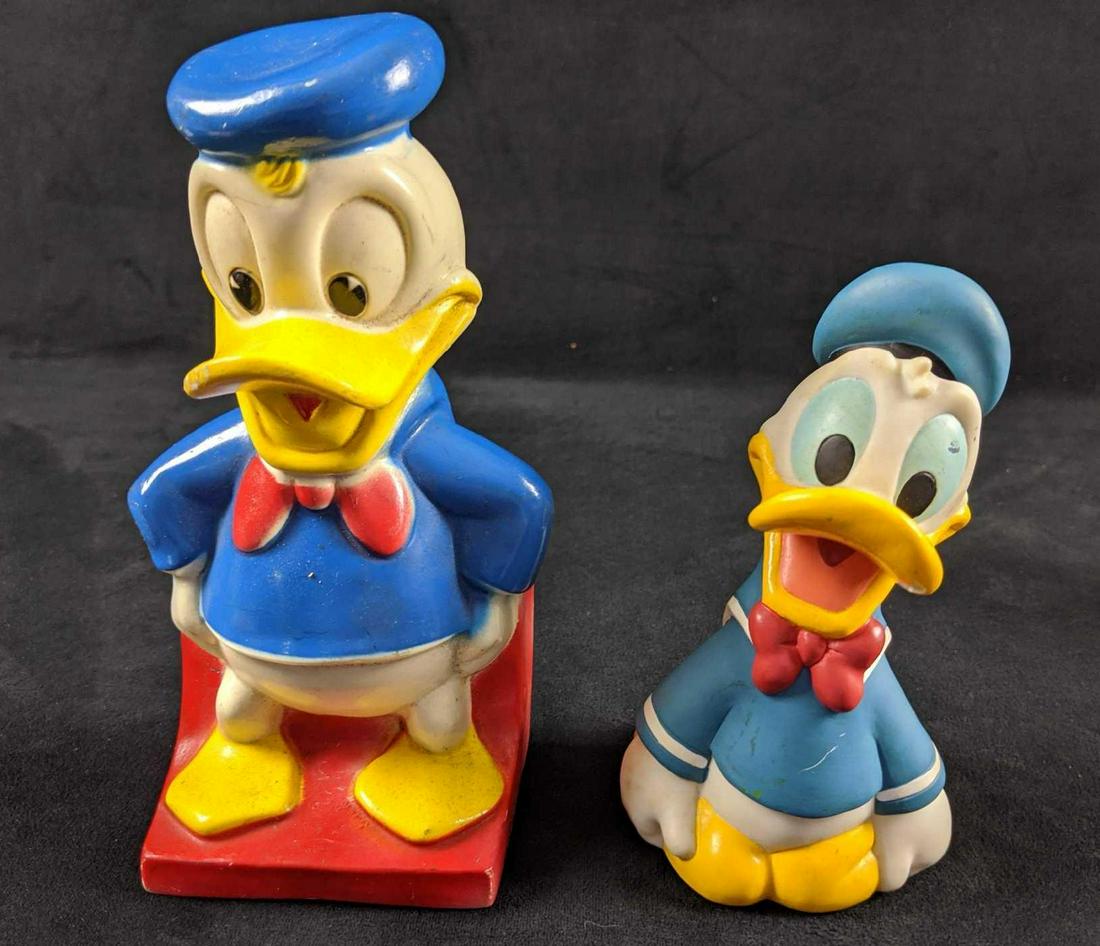 Donald Duck Vintage Piggy Banks Lot Of Two: This lot includes: One Vintage Disney Donald Duck Bank by Play Pal Plastics 1970s. Donald is in good, vintage condition with some scuffs from storage. Figure is 4" x 3" x 8". Still has original stoppe