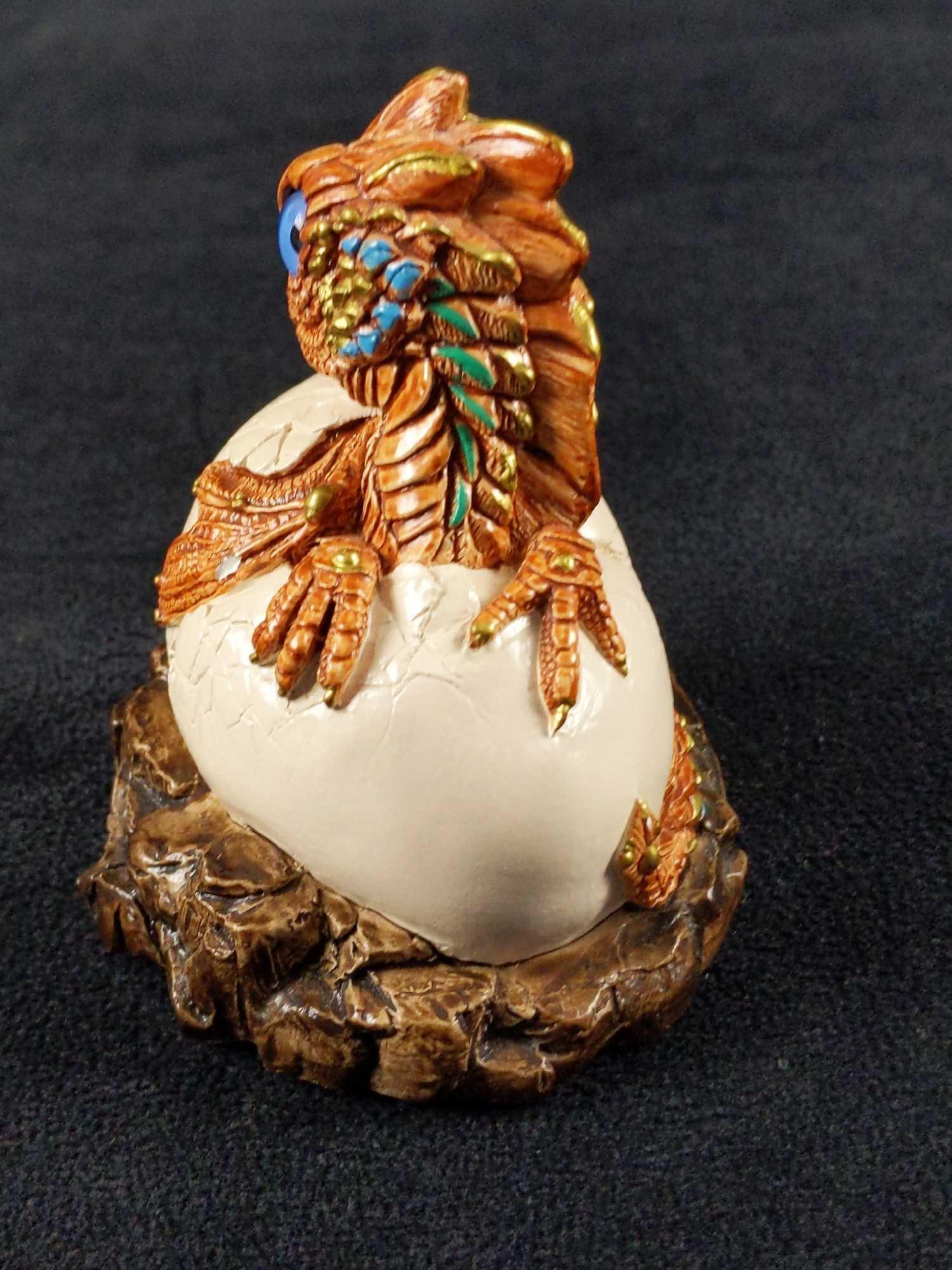 Retired Windstone Brown Dragon Hatchling V1 Brown: Windstone Editions Baby Dragon Hatchling Version 1. Brown Turquoise And Gold Highlights. Has glass eyes and a blue zircon colored Swarovski jewel in his forehead. He is made of a cast gypsum stone (a