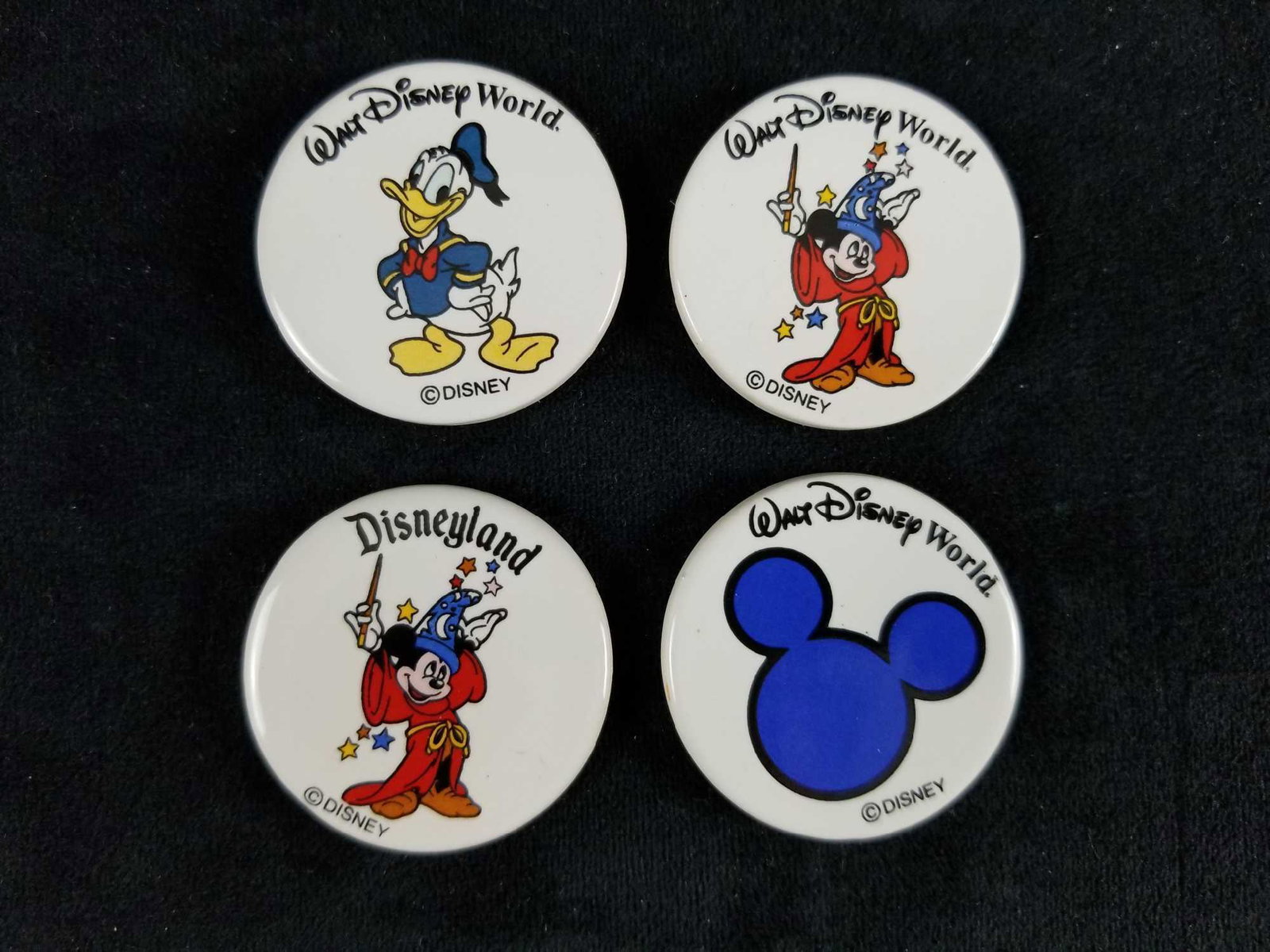 Vintage Disney Ceramic Round Refridgerator Magnets Lot: This lot is for 4 ceramic round white magnets in great used condition with no known damages . Each one measures 1.5" diameter. 1) Donald Duck 1) Blue Mickey Mouse head silhouette with a blue outline 2