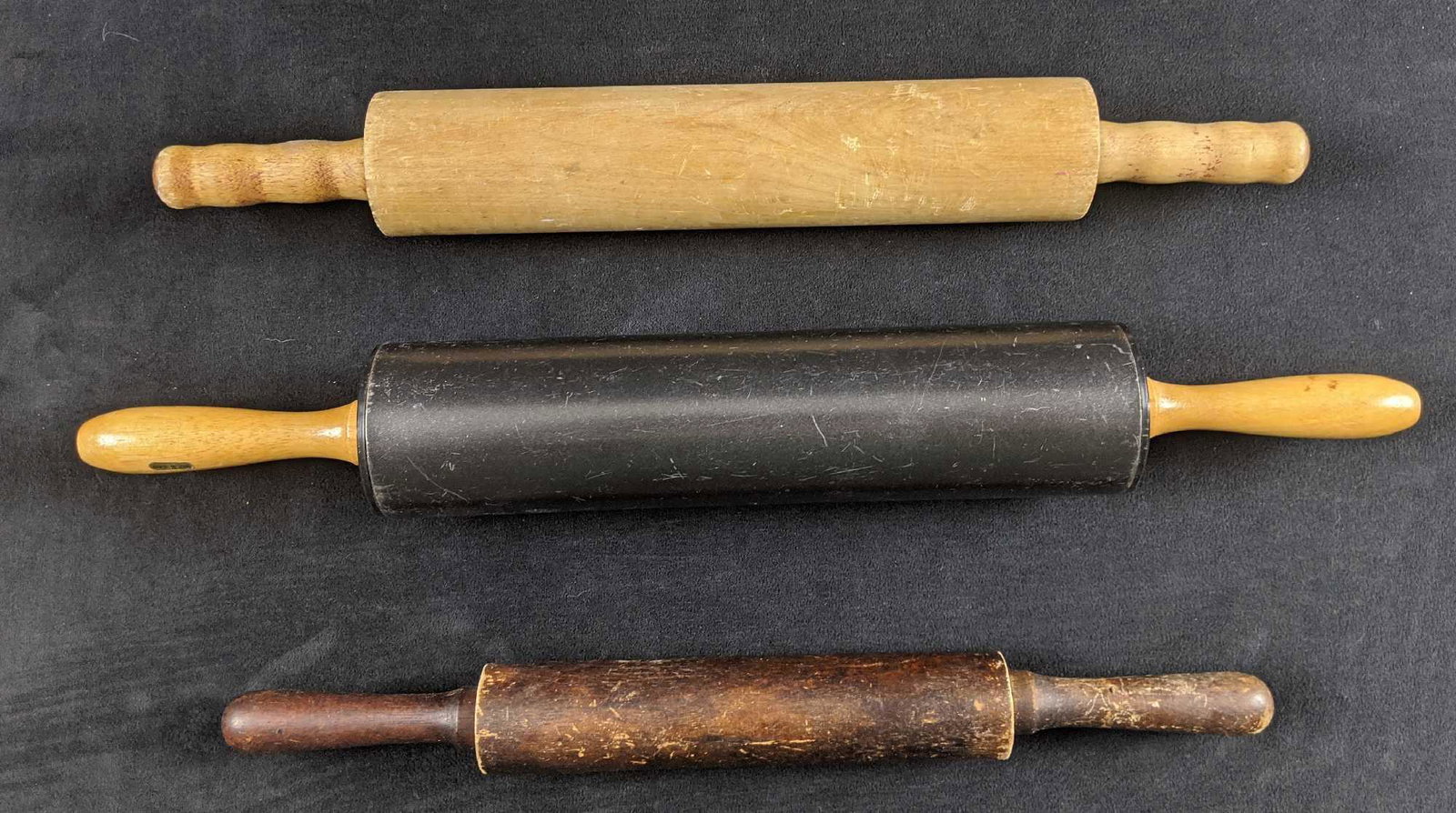 Vintage Lot Of Three Roller Pins: This lot includes three vintage roller pins. Two are fully wooden, while the largest has wooden handles with a metal roller. Rollers are all in good, vintage condition with some wearing on the rollers