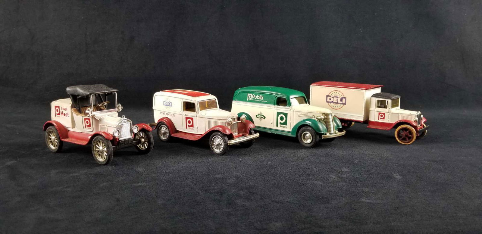 Publix Co Ertl Runabout Delivery Coin Bank Cars Lot A: This lot contains Ertl delivery vehicles for Publix Co and they are diecast coin car banks: 1- 1931 Hawkeye Truck. Deli Department. 1992 edition. The key is missing and the lock to bottom is broken. A