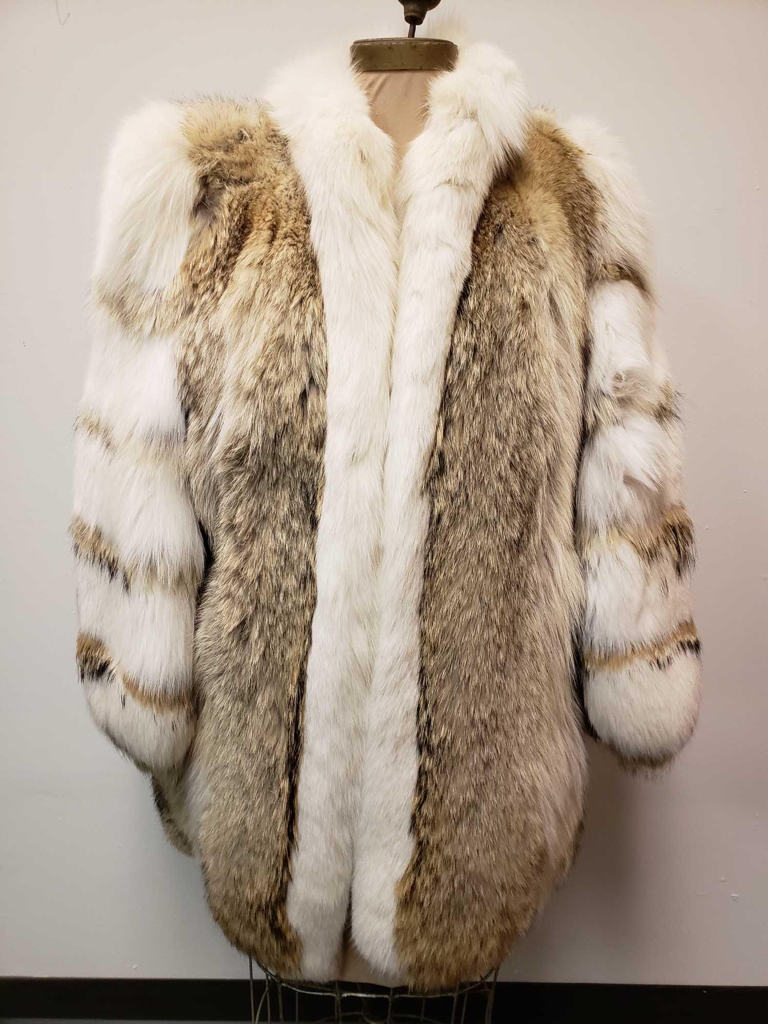 David Green Canadian Coyote and Fox Fur Coat: David Green Canadian Coyote and Fox Fur Coat. This fur coat is in great used condition. The coat has no known signs of damage to the interior or exterior. Coat has a hook and loop closure, with one in
