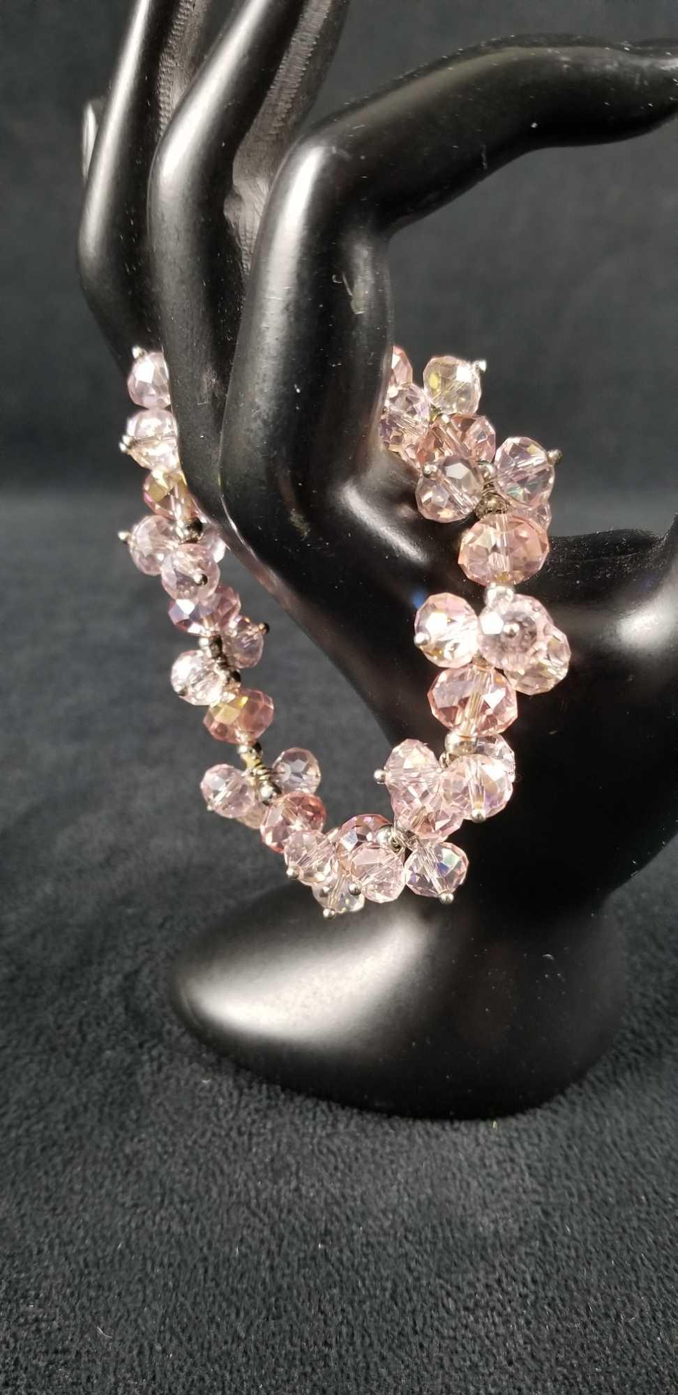 Pink Cut Glass Elastic Bracelet: Pink cut glass chunky elastic bracelet with silver filler beads. Maker unknown. In good condition with no known damages. Comes in green box. Approx. measures 2 1/2" diameter.
