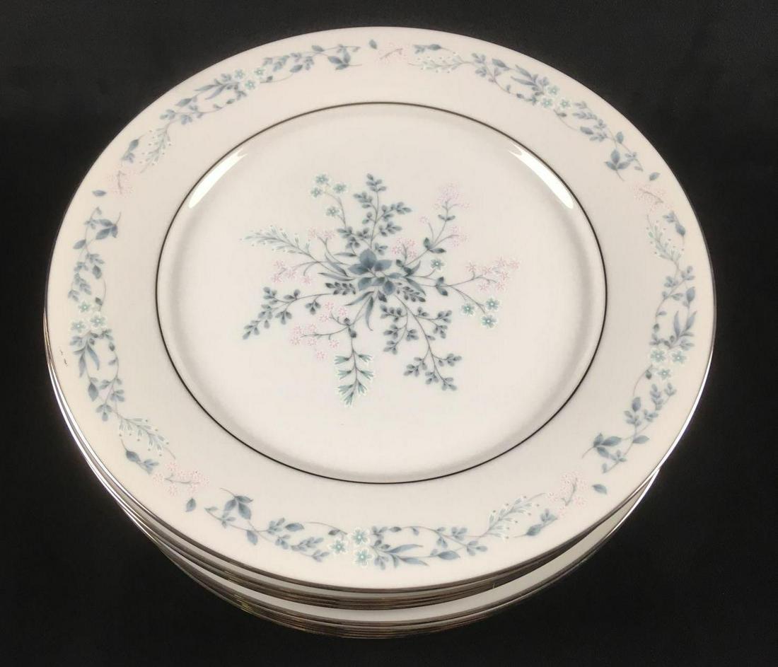 Set of 11 Carolyn by Noritake Dinner Plates: Set of 11 Carolyn by Noritake Dinner Plates. This set is in great condition. This set. There are no chips or cracks in the porcelain. The plates has a floral design in the center and around the edge. 