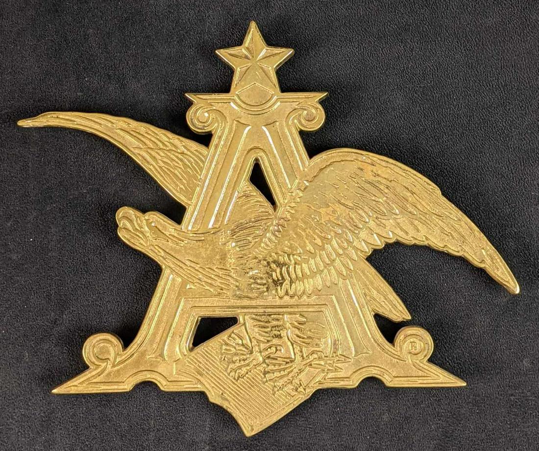 Vintage YM Solid Brass Anheuser Busch Trivet A: Vintage YM Solid Brass Anheuser Busch Trivet. Is approx 10" x 9" and is in a good, vintage condition with light surface tarnish.