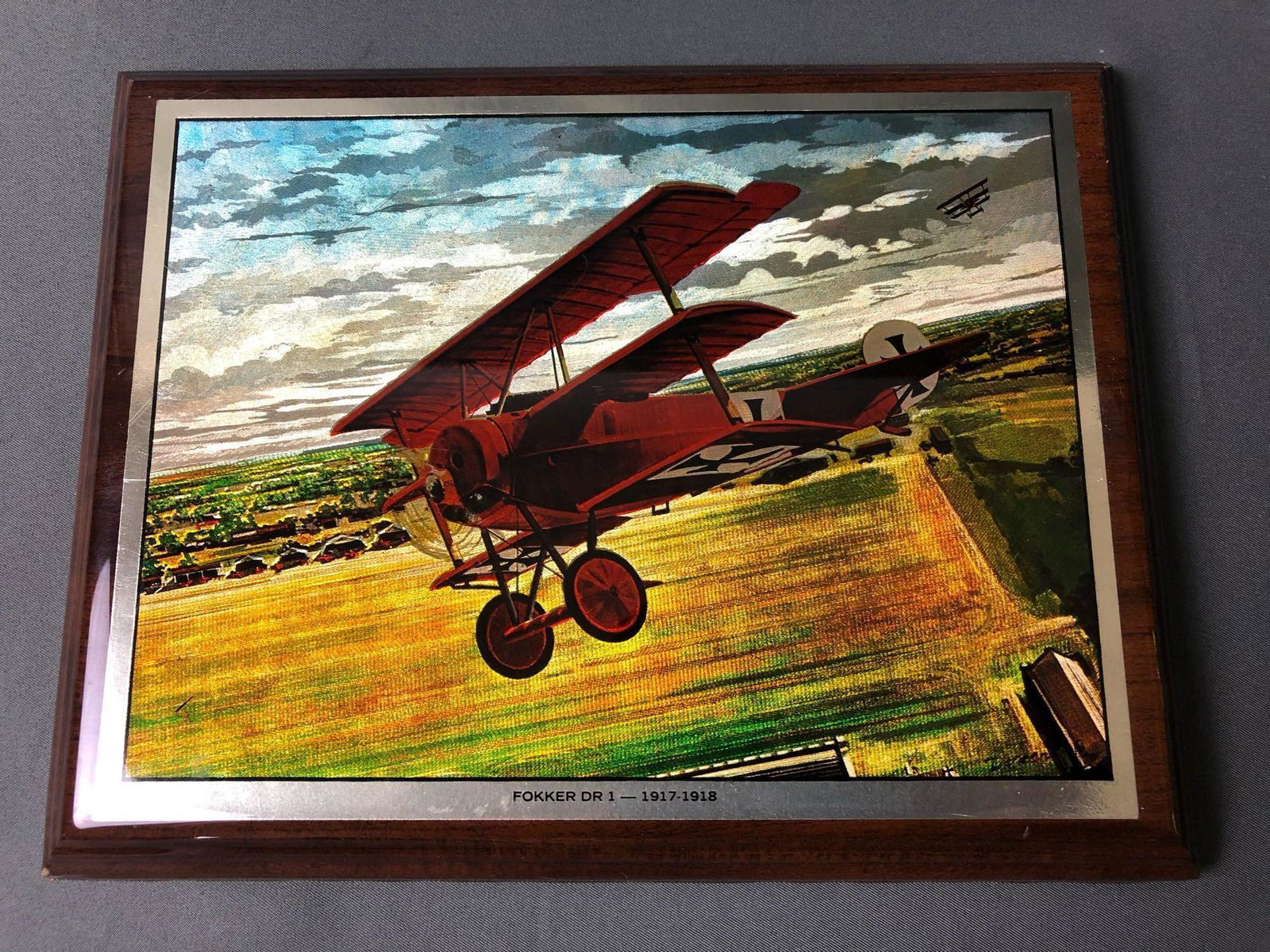 SIGNED JB DENEEN FOKKER DR 1-1917-1918 AVIATION ART WWI: JB DENEEN FOKKER DR 1-1917-1918 AVIATION ART WWI COLOR FOIL PRINT THE COLOR IN THE FOIL GIVE THE IMAGE LIFE AND THE ILLUSION OF THE AIRCRAFT FLYING AS THE EYE MOVES FROM DIFFERENT ANGLES. PRINT HAS HI