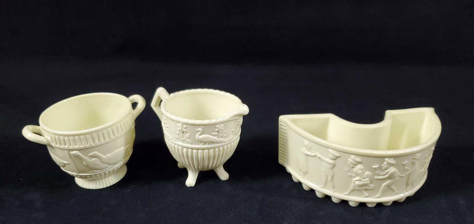 3 Antique Pottery Pieces Late 1800s: This 3 piece lot of pottery pieces has a patent marking dating it late 1800s. This lot consists of 2 cups and a trinket dish in an ivory color. One of the cups depicts geese, the other peacock and flo