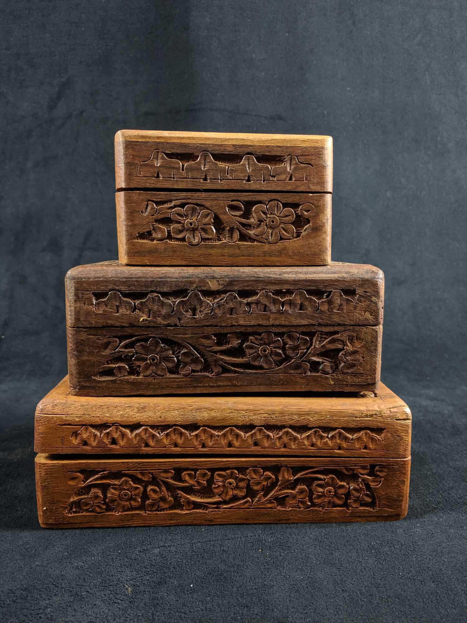 Wood Floral Trinket Boxes lot of 3: Wood trinket boxes with carved floral pattern. Lot of 3. Hinges work fine on all of the boxes. Used condition. Wood Trinket Box with carved floral design. Made in India. Dimensions : 4" x 4" x 2.5" Wo