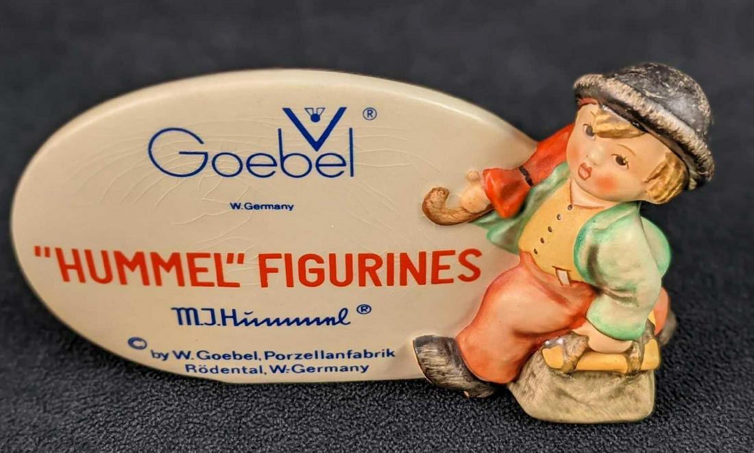 Vintage Goebel Hummel Merry Wanderer Sign TMK-5: Vintage Goebel Hummel "Merry Wanderer" collector sign (TMK-5). This was released in 1976. Is approx 6" x 1" x 3 1/2" and is in a good, vintage condition with some light crazing. Comes with its origina
