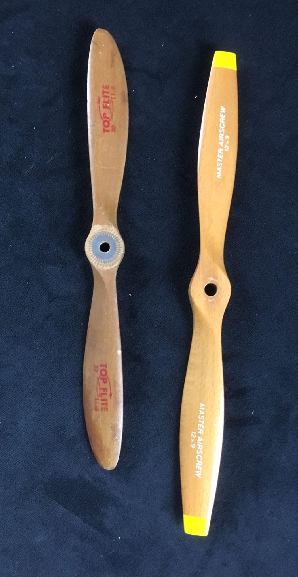 Vintage Wood Propellers: Top Flight and Master Airscrew wooden propellors, model 30 - 1.1/8 and 12X9. 12" long (Top Flight), 11" long (Master Airscrew). Both appear in decent condition.