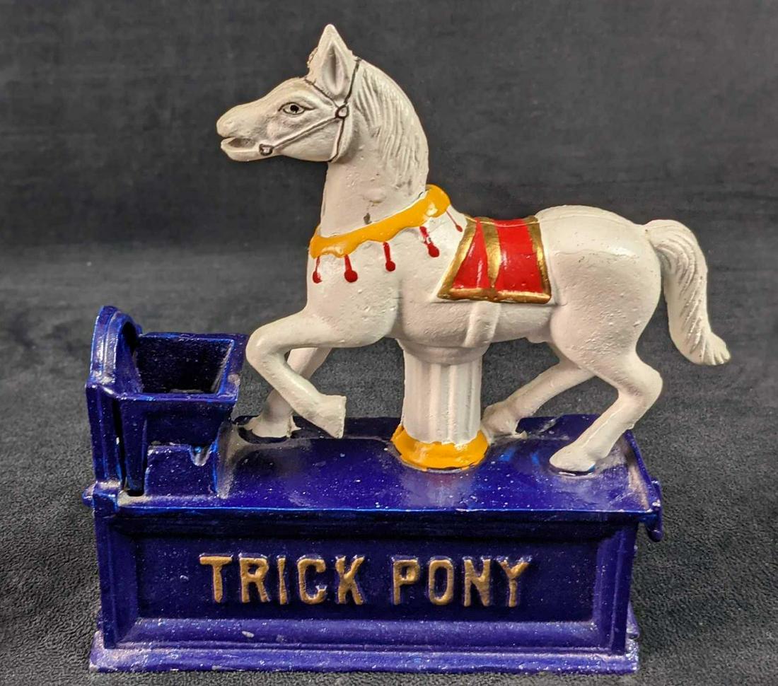 Cast Iron Mechanical Bank Trick Pony Reproduction: Hand-Painted Cast Iron Mechanical Bank Trick Pony Reproduction By The Heritage Mint Ltd. The coin is placed in the horse's mouth. Trip the lever on the end of the bank and the horse lowers its head an