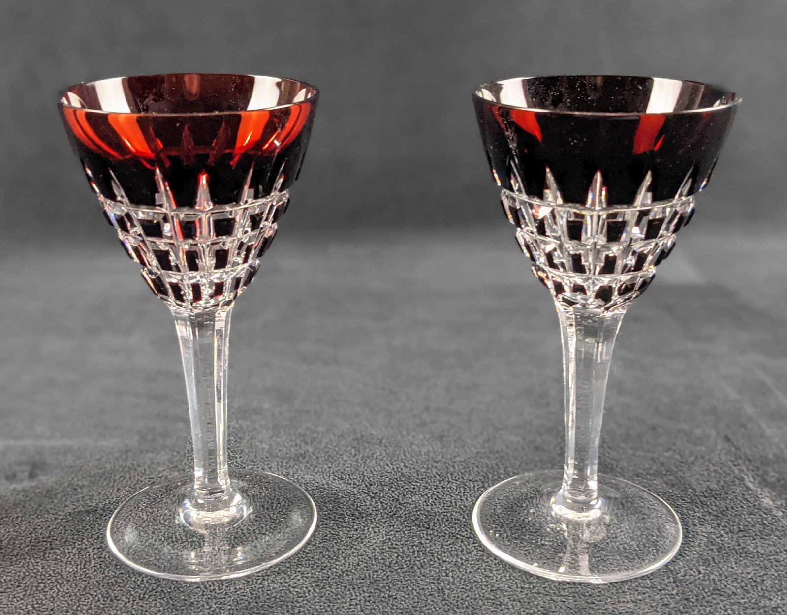 Two Textured Small Stemmed Wine Glasses: Two Textured Small Stemmed Wine Glasses. The maker and date of creation are unknown. The color on the top slowly turned dark as it goes down to the bottom of the glass. Glasses are approx 2 1/2" x 2 1