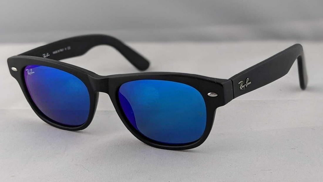 Ray Ban New Wayfarer Blue Flash Black Frame Sunglasses: Ray-Ban New Wayfarer Matte Flash sunglasses are an exclusive model of the Wayfarer family. Featuring the same style and fit as the New Wayfarer Classic, New Wayfarer Matte Flash RB2132 sunglasses are 