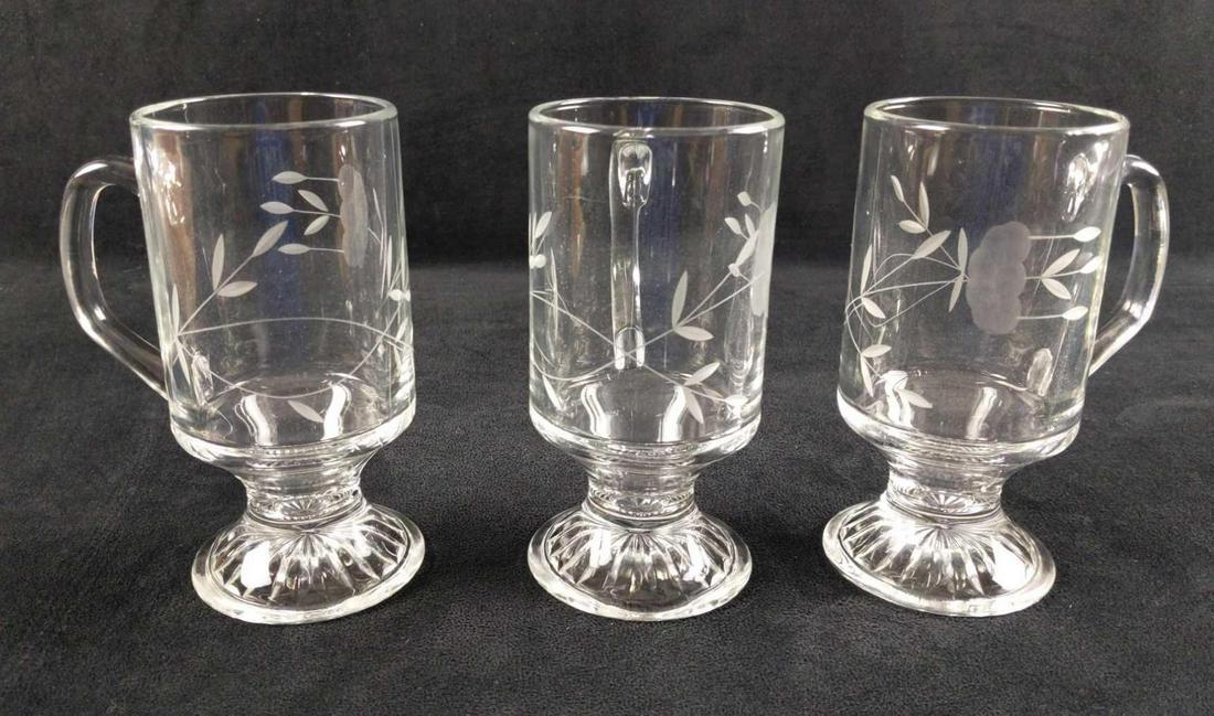 Three Heritage By Princess House Irish Coffee Cups: Three Heritage By Princess House Glass Irish Coffee Cups. Each has a flower etched on their sides. Glasses are approx 4" x 2 3/8" x 5 1/2". Glasses are in good, unused condition with no known damage.