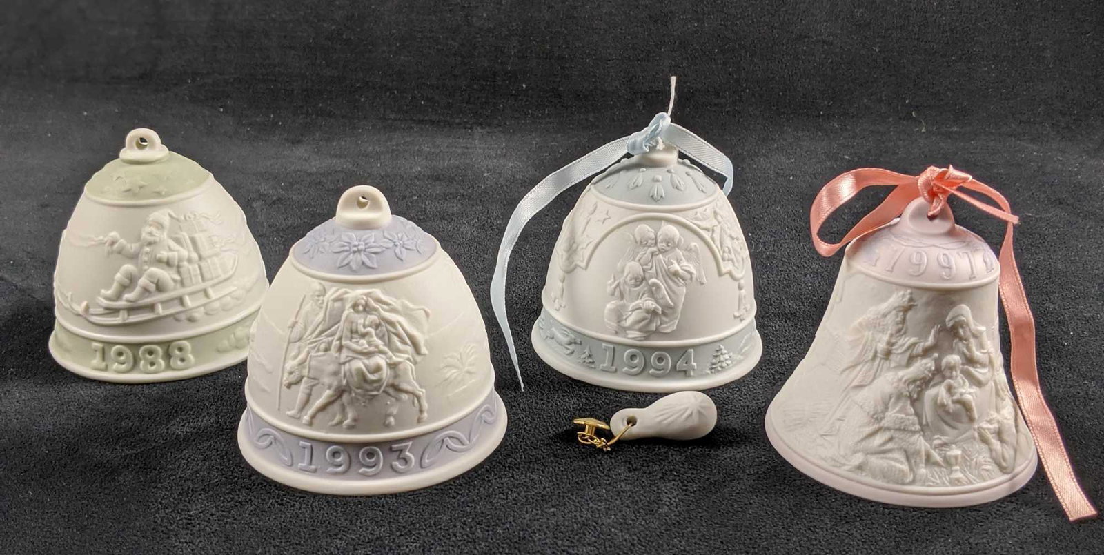 Lladro Annual Bell Ornaments 88 93 94 97 G: This lot of LLadro Annual Bell Ornaments includes: 1988 1993 1994 (Ringer Loose) 1997 All Bell Ornaments are in good, used condition only some minor wearing on the bottoms of some ornaments. All come 