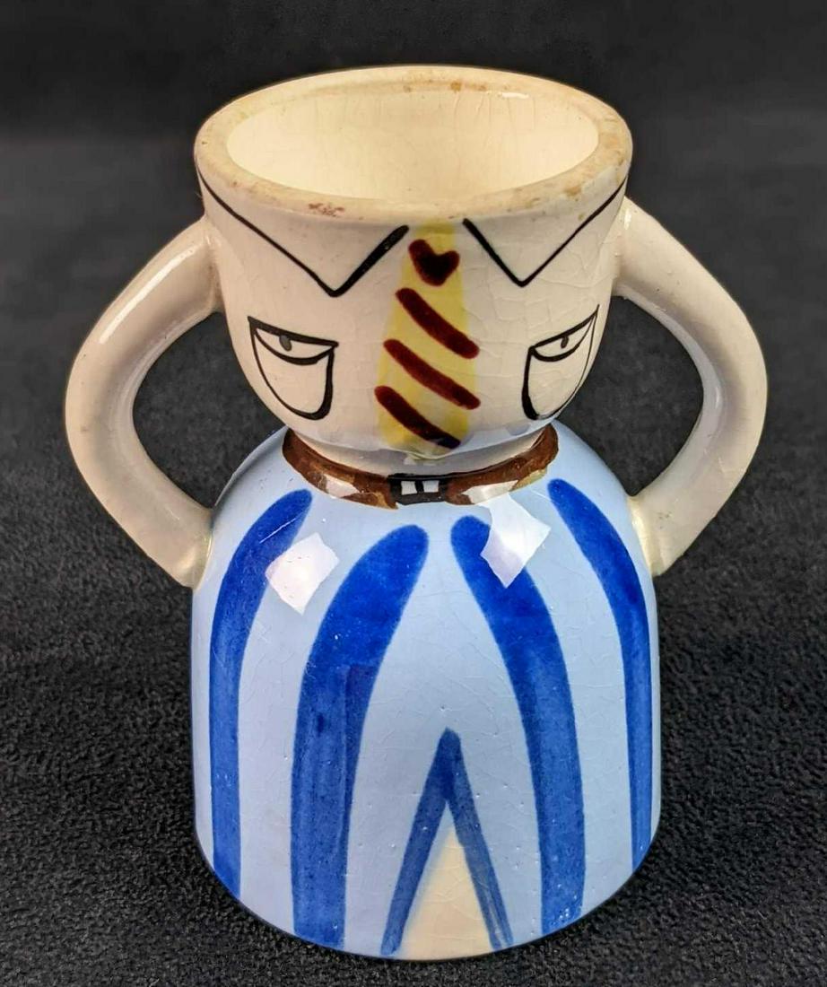 Vintage Hand Painted Napco Ceramic Egg Cup Suit And Tie: Vintage Hand Painted Napco Ceramic Egg Cup. This one has a painted design of dress shirt with a tie and blue pants. This is approx 4" x 2 1/2" x 4". Is in a good, vintage condition with wear and a sli