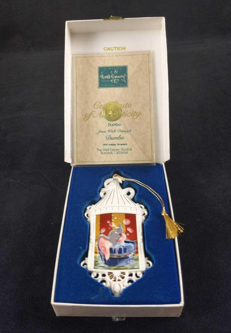 Disney Collectors Society Dumbo Holiday Ornament: Disney Collectors Society Dumbo 1995 Holiday Porcelain Ornament. Comes with COA and original box. Ornament is approx 2 1/4" x 5 1/2". Comes with ordinals box which is approx 4 1/4" x 1" x 6". Ornament