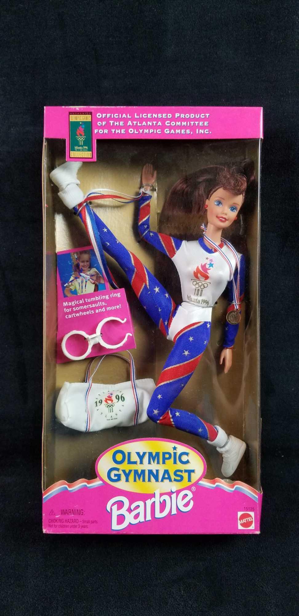 Olympic Gymnast Barbie: Olympic Gymnast Barbie in box. This Barbie was designed for the Atlanta 1996 Games. Still in box, unused, and all accessories included. In good vintage condition. Approx. measures 6 1/2" x 2 1/2" x 12