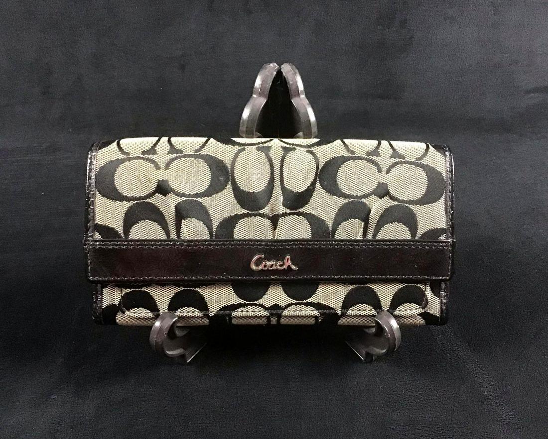 Traditional Coach Pattern Canvas Leather Clutch: This is a Coach clutch featuring the traditional monogram pattern they are known for. The inside is lined with black calf leather. The snap and zipper work perfectly. There are minor scuffs and no oth