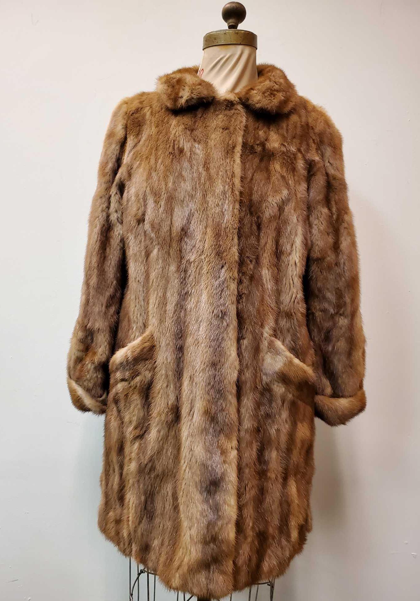 Brown Vintage Mink by Hoeber and Malkowsky Moers: This brown vintage mink fur coat by Hoeber and Malkowsky Moers features cuffed wrists, brown linen interior, 4 hook and loops for closure and 2 exterior pockets. This coat is in good used condition wi