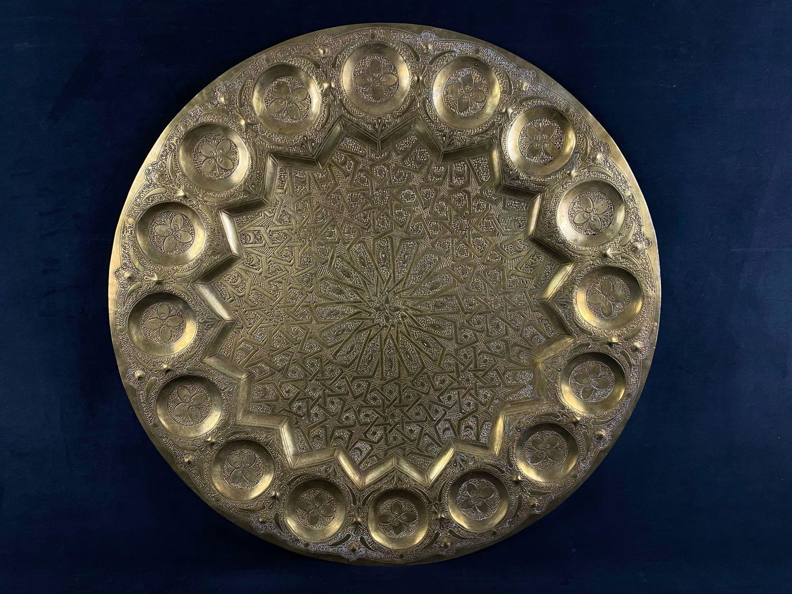 26" Middle Eastern Moorish Antique Round Brass Tray /: Middle Eastern Moorish antique round brass tray. This handcrafted circular brass platter is decorated and hammered with Islamic Moorish floral designs. Heavy brass with very fine hand chased floral an