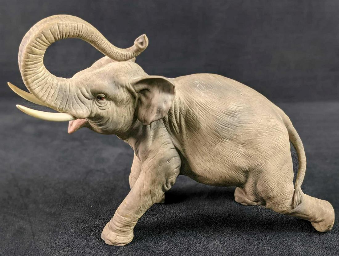 Andrea By Sadek Porcelain Elephant Trunk Up: Hand-Painted Andrea By Sadek Porcelain Elephant With Trunk Up. Is approx 11" x 3" x 8 1/2". The elephant is in a good, used condition with a crack on the right trunk.