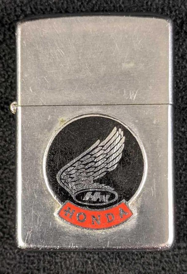 Vintage Honda Zippo Lighter: Vintage Honda Zippo Lighter This Honda Zippo lighter does not work. It is a great piece for collectors. It has the Honda Motors wings logo on it and Zippo engraved on the bottom. 0.14lbs
