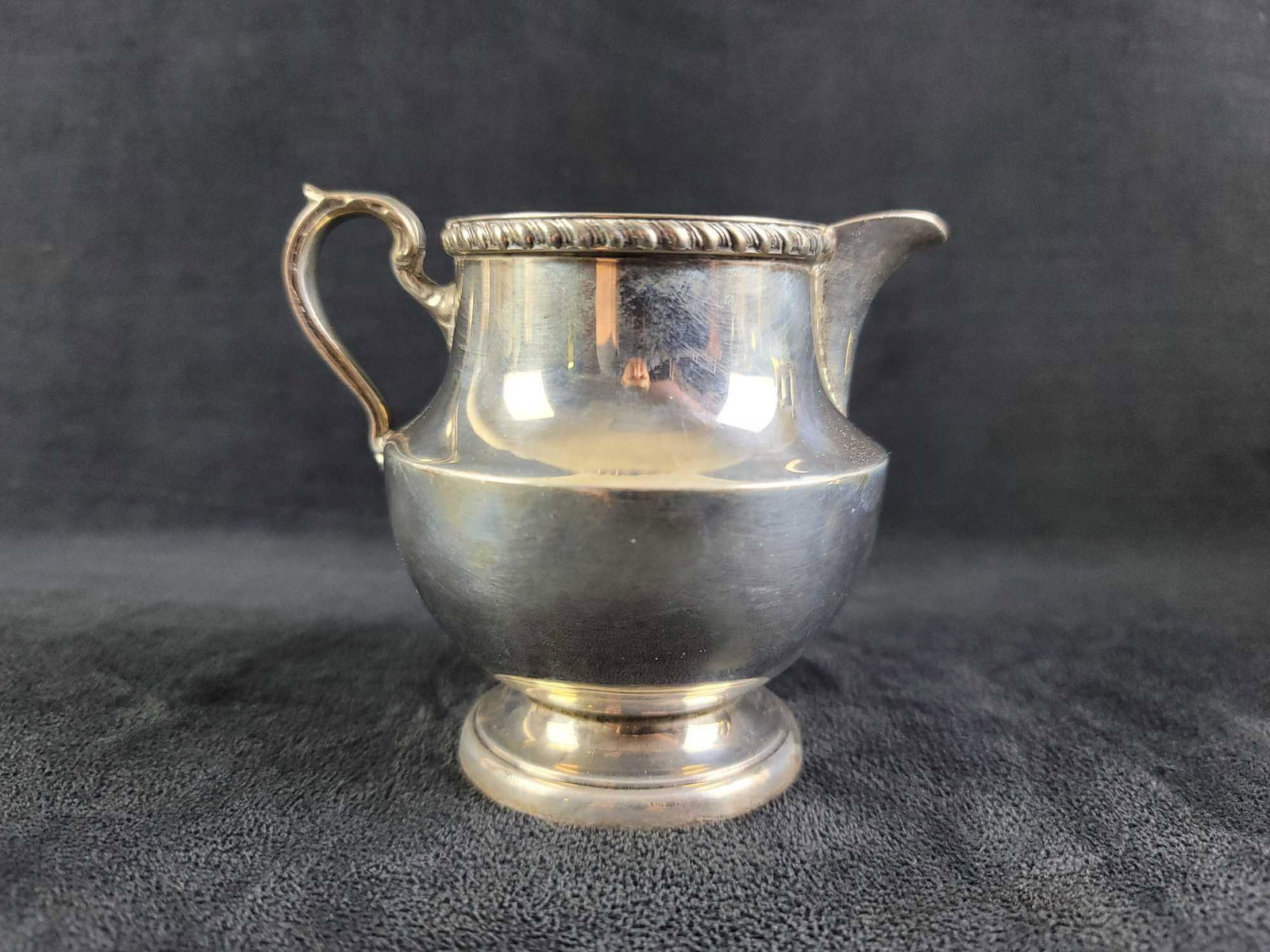 Antique Sterling by Poole 1027 Georgian Creamer: Antique Sterling by Poole 1027 "Georgian" is stamped by maker on the bottom. Has a nice gadroon pattern around rim. No lid, has a handle and spout. In good condition, needs a good polish. Approx. meas